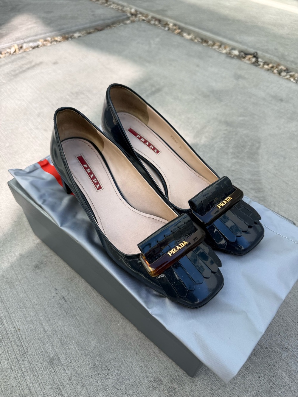 Prada Black Patent Leather Fringe Pump with Gold Logo Accent